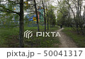 Woman Walking on a Path Surrounded Green Trees. 50041317
