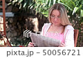 Young woman reads the newspaper 50056721