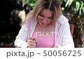 Young woman reads the newspaper 50056725