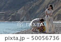 Happy parents and the daughter walk on the coast in the sunny day 50056736