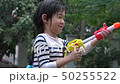 Cute Asian child playing with water gun  50255522