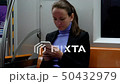 Woman texting in smartphone sitting at subway car 50432979