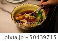 Woman eat yummy chinese dumpling soup 50439715