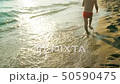 Child naked and barefoot running along the beach on a sunset summer day FullHD 50590475