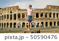 The girl is spinning near the Colosseum in Rome. She's happy. FullHD 50590476