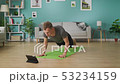 A young man studies yoga using instructions on a tablet 53234159