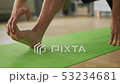 Young man doing stretching in his living room 53234681