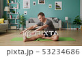 Medium shot of young man doing yoga in the morning in his living room 53234686