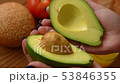 Woman opening an avocado in two parts 53846355
