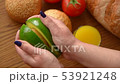 Woman opening an avocado in two parts 53921248