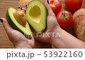 Woman opening an avocado in two parts 53922160