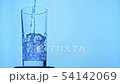 pouring mineral water in transparent glass, ice 54142069