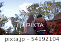 Following tow women though Temple court in Kyoto. 54192104