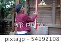 Japanese woman praying at Kyoto shrine. 54192108
