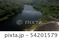 Flying from the beach to a lagoon in the forest. 54201579