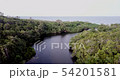 Flying over a lagoon towards the beach. 54201581