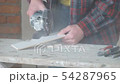 Worker cuts ceramic tiles with an angle grinder 54287965