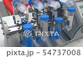 In a laboratory, a scientist analyzes a colored liquid to extract the DNA and molecules in the test 54737008