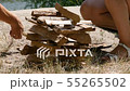A man and girl tries to lay down a fire. Tourism, travel, green tourism concept. River and forest in 55265502