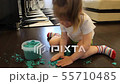 Child collects kinetic sand into the jar after the game 55710485