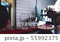 The bartender makes a burning cocktail and lights it with a lighter. 55992375