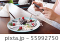 Food blogger hands using smartphone taking photo of beautiful beef steak on wood table inside the 55992750