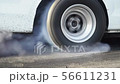 Drag racing car burn tire at start line 56611231