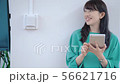 Smiling woman holding a tablet 56621716