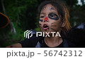 Girls is walking in the dark woods in halloween 56742312