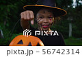Girl is showing a pumpkin toy in halloween 56742314