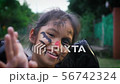 Girl with painted face walking alone in halloween 56742324