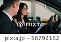 Male consultant shows functions of car to woman client 56792162