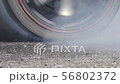 Drag racing car burning tire at starting line in r 56802372