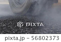 Drag racing car burning tire at starting line in r 56802373