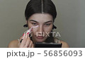 Young Caucasian Woman Concealing Acne. Make Up Procedure 56856093