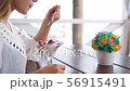 Portrait of happy young beautiful girl eating a dessert in restaurant on the seashore. 56915491