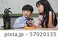 Children is playing with robotic arm in a school. They is controlling it hand. Technology and Innovation concept. 57020135