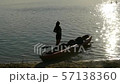silhouette of a woman near a kayak on the lake 57138360