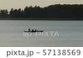 people kayaking on the lake in the evening on sunset 57138569