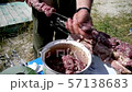 man puts barbecue on skewer 57138683