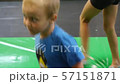 The autistic boy jumps on a trampoline and spins around his axis, while his eyes look to the side 57151871