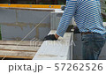 Bricklayer putting down another row of bricks in site 57262526