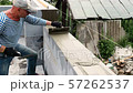 Bricklayer putting down another row of bricks in site 57262537