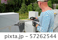 Bricklayer putting down another row of bricks in site 57262544