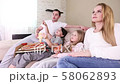 Family watching TV at home 58062893