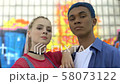 Stylish male and female teenagers looking camera 58073122