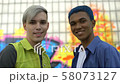 Pierced teenage friends near graffiti wall 58073127