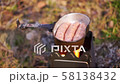 Cooking sausages on twig stove outdoors, close up 58138432