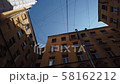Sky and buildings with a web of wires 58162212