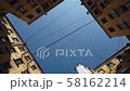 Sky and buildings with a web of wires 58162214